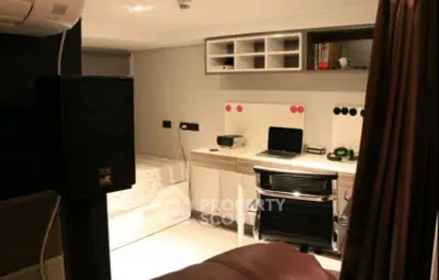 Modern study room with sleek desk, chair, and built-in storage in a cozy apartment.
