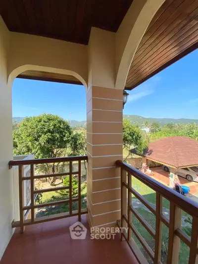 Charming balcony with scenic mountain views and wooden railing, perfect for relaxation.