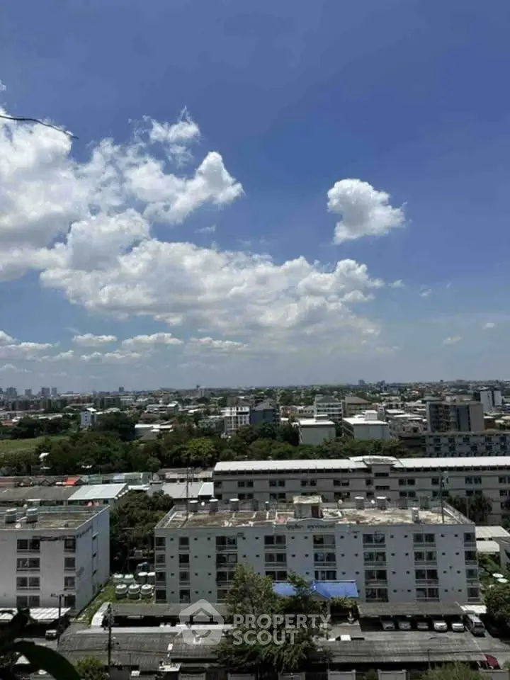 Stunning cityscape view from high-rise building showcasing urban skyline and clear blue skies.