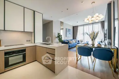 Luxurious open-plan kitchen and living room with modern decor and elegant lighting