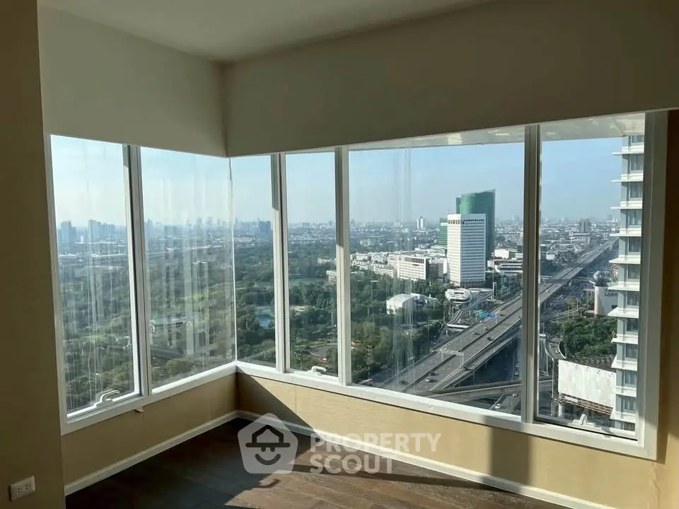 Stunning corner unit with panoramic city view from floor-to-ceiling windows, perfect for urban living.