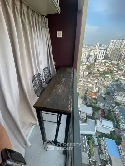 Stunning high-rise balcony with cityscape view, perfect for relaxation and enjoying urban living.