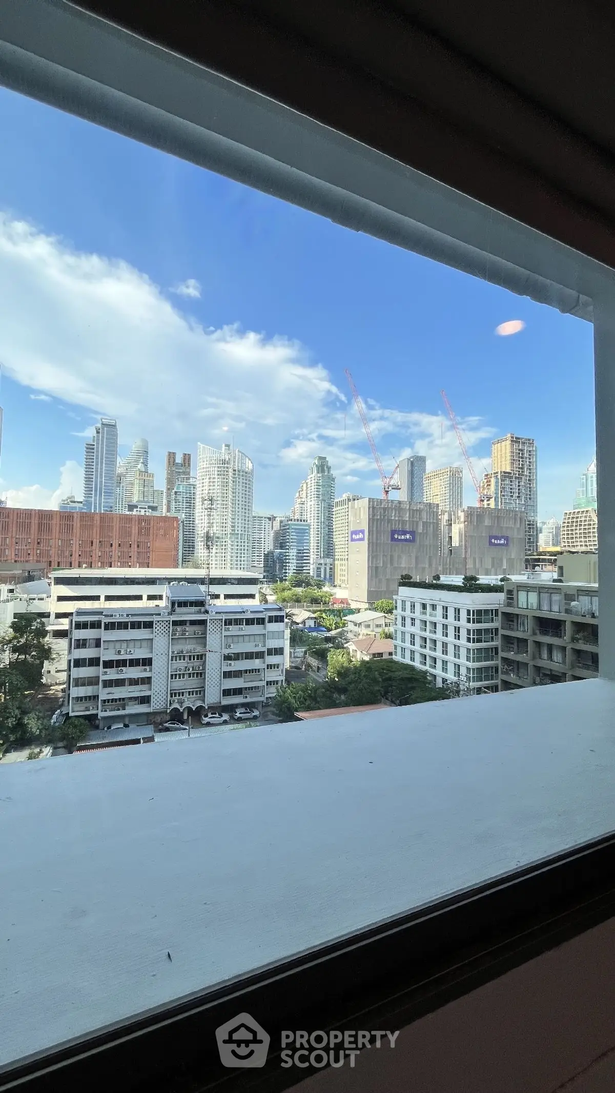 Stunning cityscape view from a high-rise window showcasing modern urban skyline.