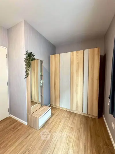 Spacious bedroom with modern wooden wardrobe and stylish decor