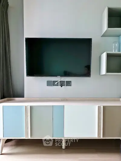 Modern living room with sleek TV setup and stylish storage unit