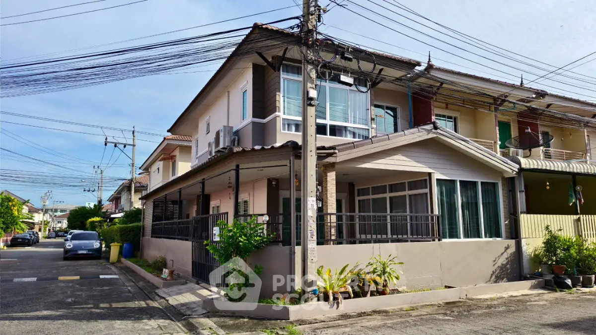 Charming corner townhouse with large windows and balcony in a quiet neighborhood.