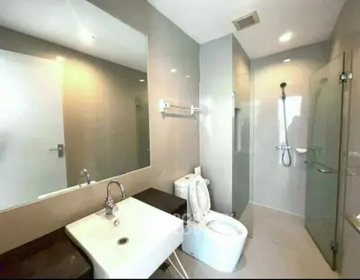Modern bathroom with sleek fixtures and glass shower enclosure