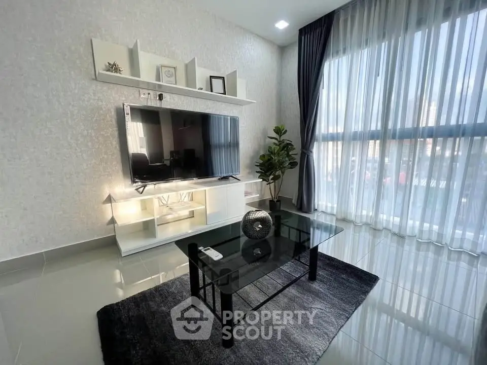 Modern living room with sleek TV setup and large window view