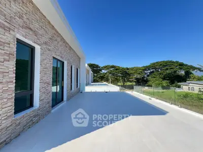 Spacious modern balcony with glass railing and scenic view