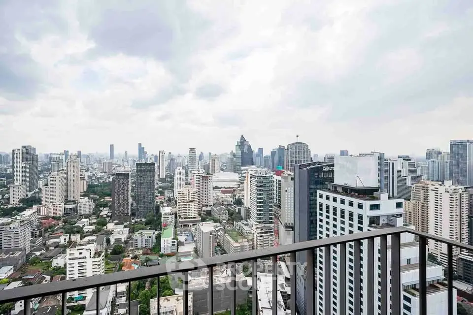 Stunning cityscape view from a high-rise balcony in a bustling urban area.