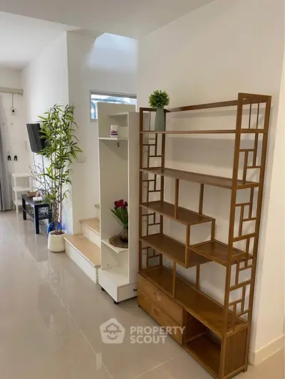 Modern living room with stylish shelving and sleek flooring, perfect for contemporary living.