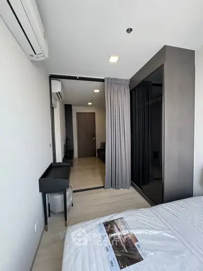 Modern bedroom with sleek design and air conditioning in a stylish apartment.