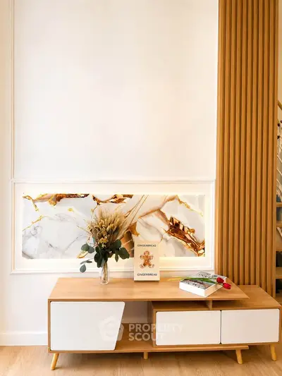 Stylish modern living room with elegant wooden furniture and decorative marble accent wall.