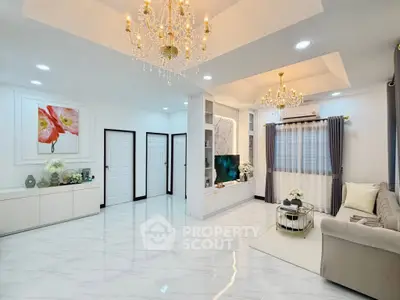 Luxurious living room with elegant chandeliers and modern decor, perfect for sophisticated living.