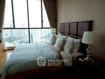 Luxurious bedroom with city view and elegant decor in high-rise apartment