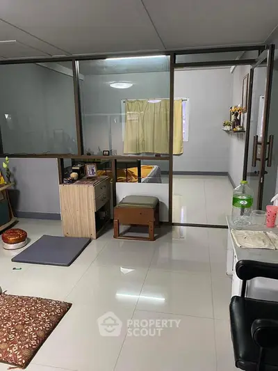 Modern interior with glass partition and sleek flooring, ideal for versatile living spaces.