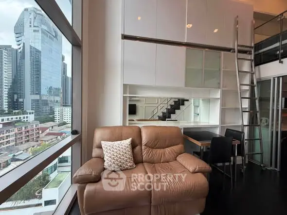 Modern loft apartment with city view, featuring a cozy leather sofa and stylish mezzanine.