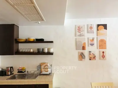 Charming kitchen with open shelving and artistic wall decor, featuring a cozy and inviting atmosphere.