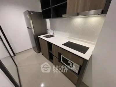 Modern kitchen with sleek design, featuring built-in appliances and stylish cabinetry.