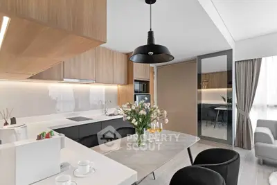 Modern kitchen with sleek design, open layout, and elegant dining area in contemporary apartment.