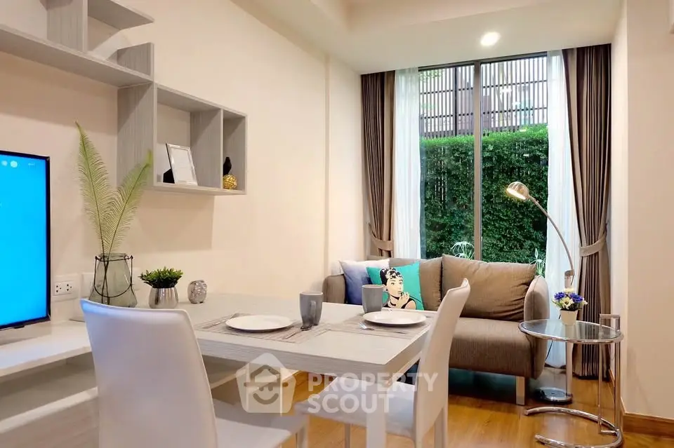 Modern living room with stylish decor and garden view, featuring a cozy sofa and elegant dining area.