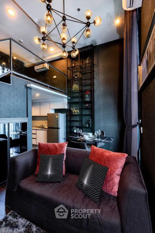 Luxurious modern living room with high ceiling and stylish chandelier in a contemporary apartment.