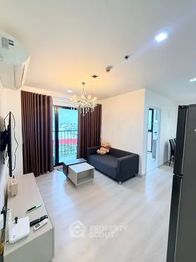 Modern living room with balcony, chandelier, and sleek furniture in a bright apartment.