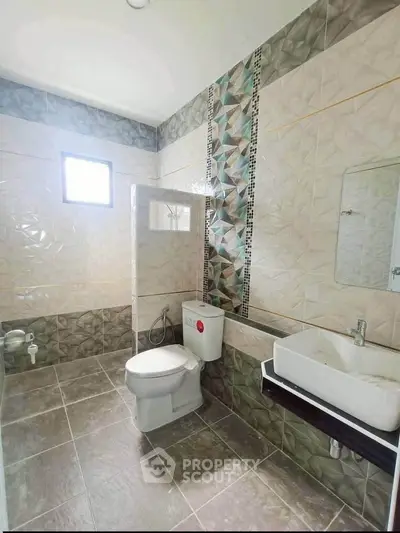 Modern bathroom with geometric tile design and sleek fixtures
