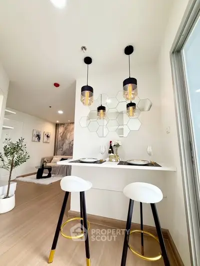 Modern kitchen with stylish bar stools and geometric wall decor