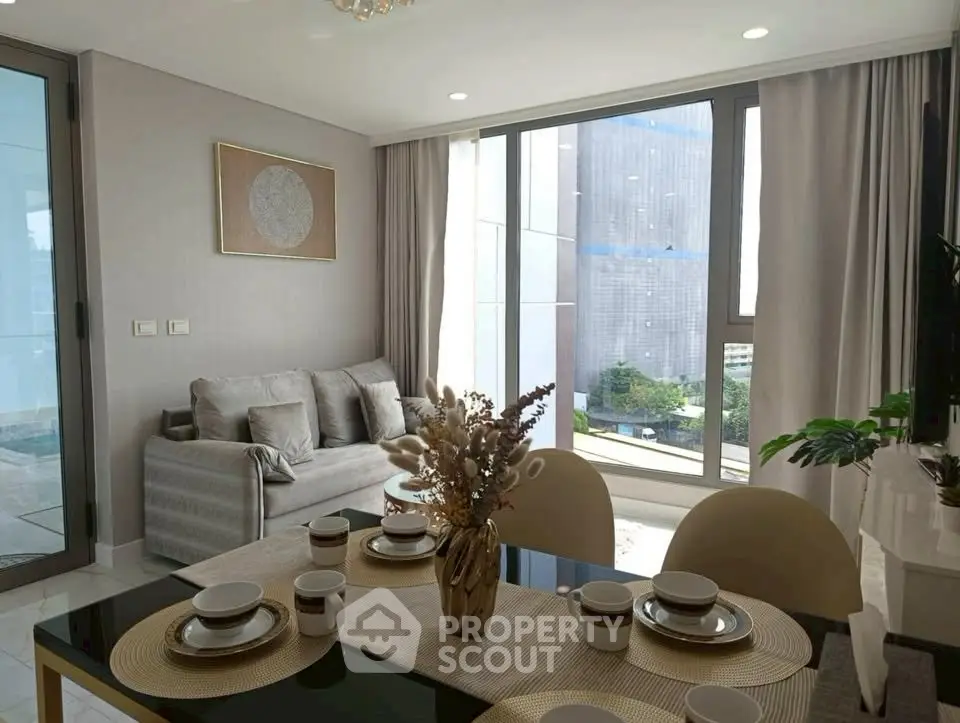 Modern living room with elegant dining area and large windows offering city views.