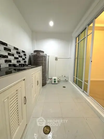 Modern kitchen with gas stove and sleek white cabinetry