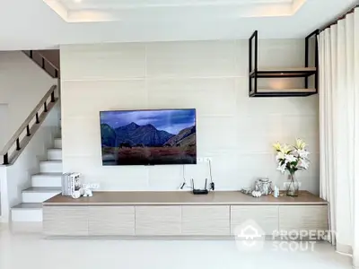 Modern living room with wall-mounted TV and elegant decor