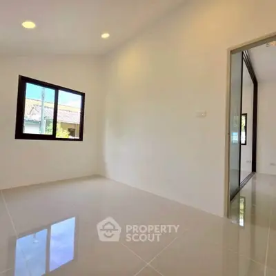 Bright empty room with large window and glossy tiled floor, perfect for customization.
