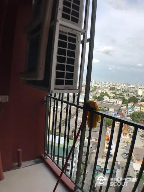 High-rise balcony with cityscape view and open window shutters