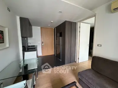 Modern compact apartment with sleek kitchen and cozy living area