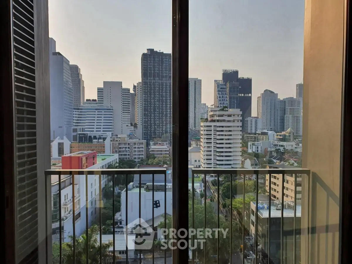 Stunning cityscape view from a high-rise balcony in a modern urban apartment.
