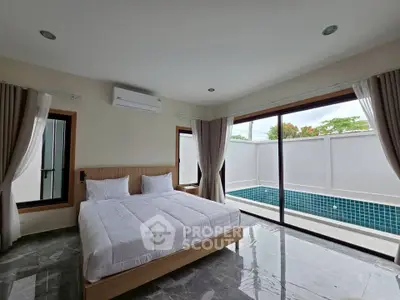 Luxurious bedroom with pool view and modern design, featuring large windows and elegant decor.