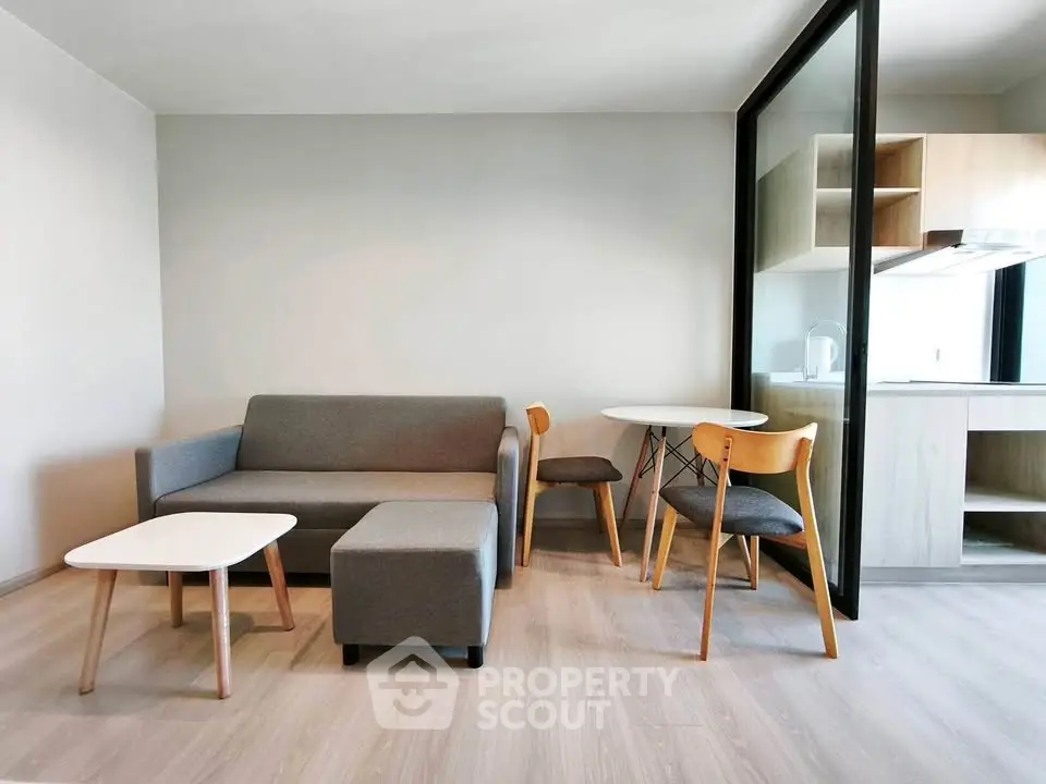 Modern living room with sleek furniture and open kitchen layout