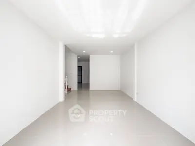 Spacious minimalist interior with glossy tiled flooring and bright lighting