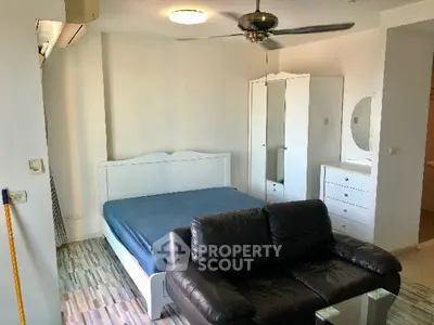 Spacious bedroom with modern furniture and ceiling fan, perfect for comfort and relaxation.