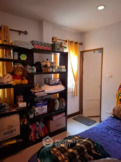 Cozy bedroom with ample storage and natural light, perfect for a comfortable living space.