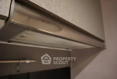Modern kitchen with sleek under-cabinet range hood and stylish design.