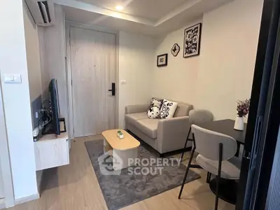 Cozy living room with modern decor and compact furniture in a stylish apartment.