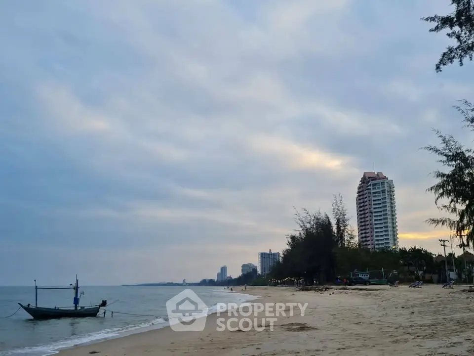 Stunning beachfront view with high-rise buildings and serene ocean waves.