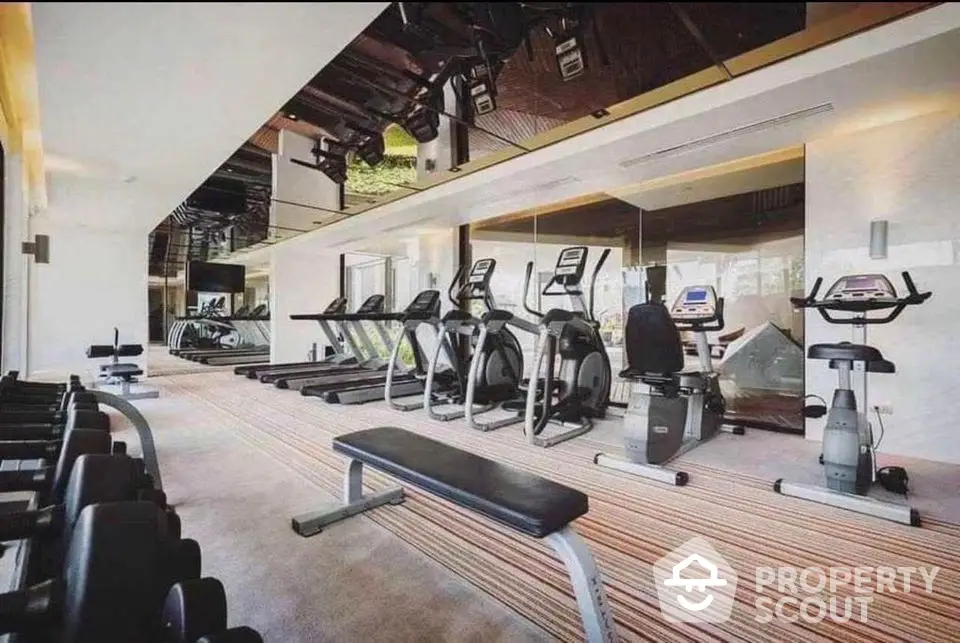 Modern gym with state-of-the-art equipment in luxury residential building.