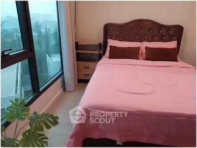 Cozy bedroom with large window and stylish bed in modern apartment