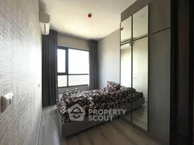 Modern bedroom with large mirrored wardrobe and stylish decor