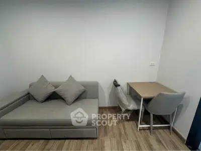 Modern living room with cozy gray sofa and compact dining table set