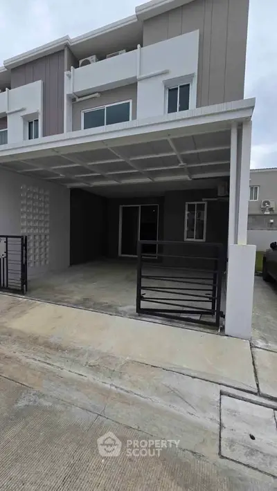 Modern townhouse with covered parking and sleek exterior design