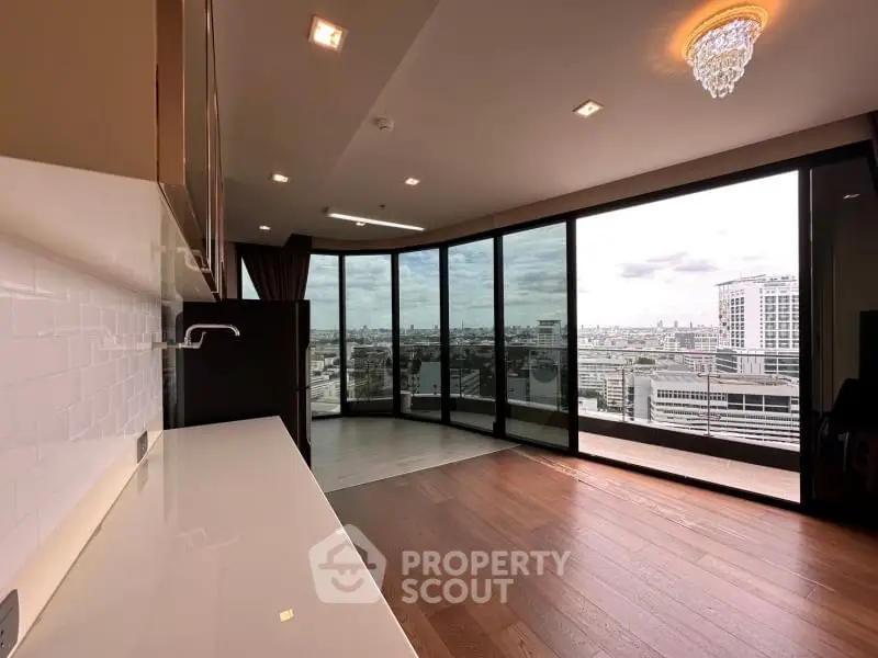 Spacious modern living room with panoramic city view and elegant chandelier